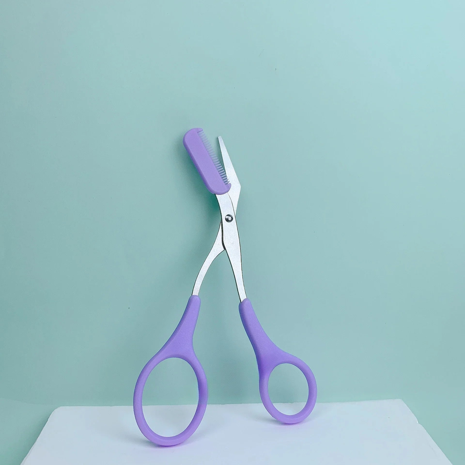Pink eyebrow trimming scissors with built-in comb - stainless steel, precise grooming tool, creating perfect eyebrows